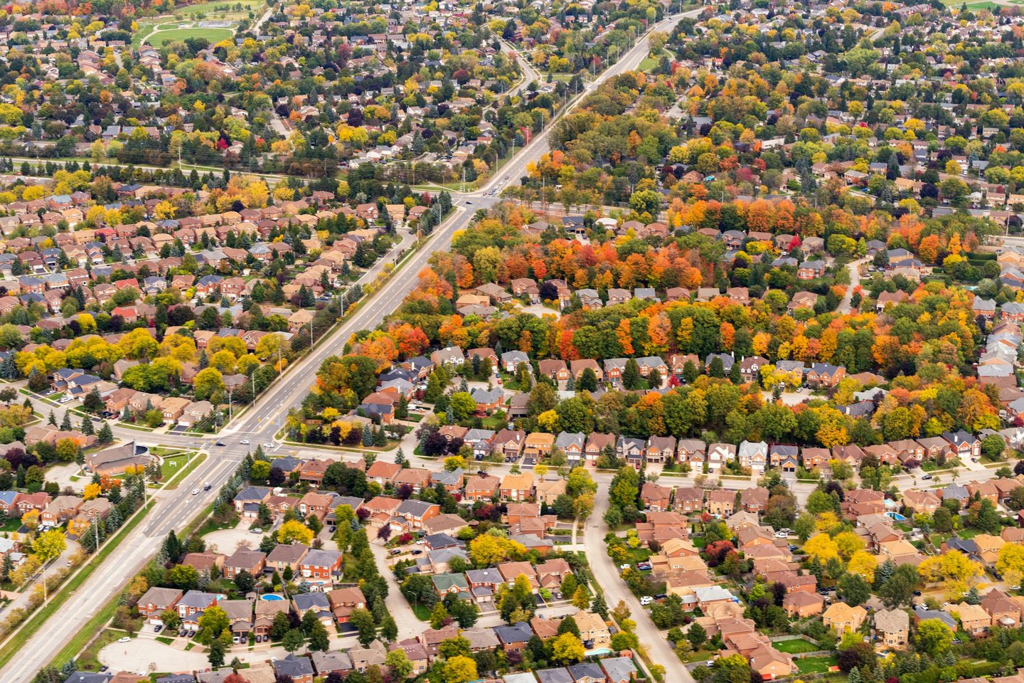 Aerial view of suburban streets and a main road in autumn